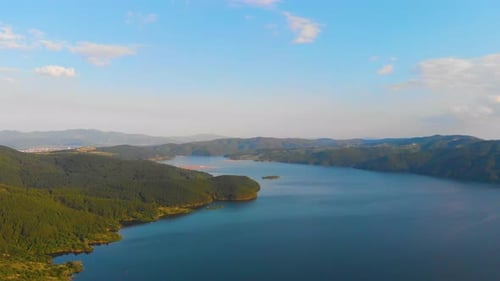 Looking the horizon and flying over a lake to turn around towards the land view.