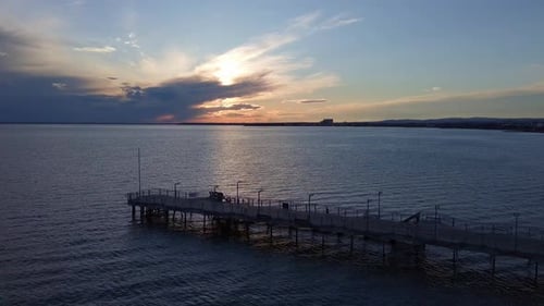 Side View of the Pier on the Black Sea Against the Background of the Sky and Sunset