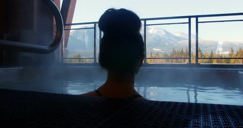 Woman relaxing in swimming pool