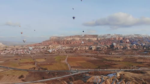 Scenic Landscape with Hot Air Balloons Ascending