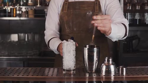 Bartender Preparing Cocktail Behind the Bar