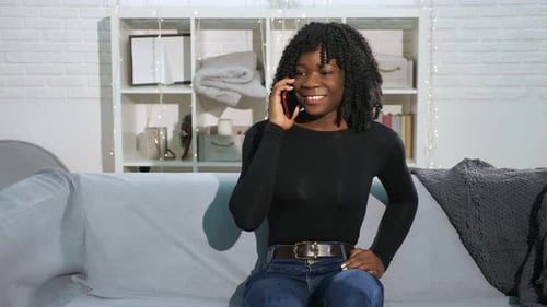 Woman Talking on Phone in Living Room