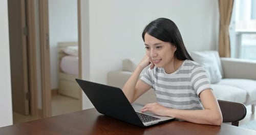 Woman Using Laptop in Contemporary Home Interior