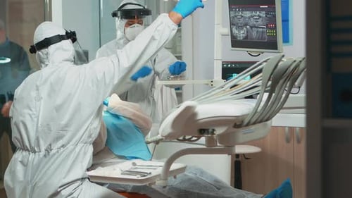 Dentist Performing Dental Treatment On Patient