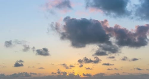 Beach Sunset with Fluffy Gray Clouds