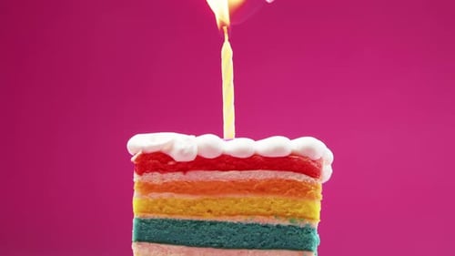 Colorful Cake Slice with Lit Birthday Candle