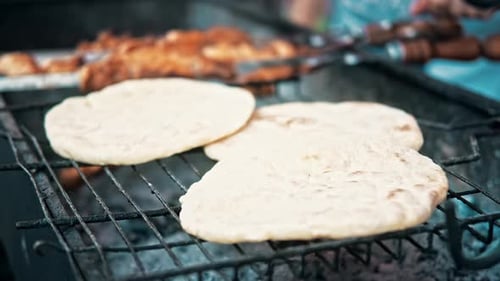 Flatbreads frying on a grill at food festival