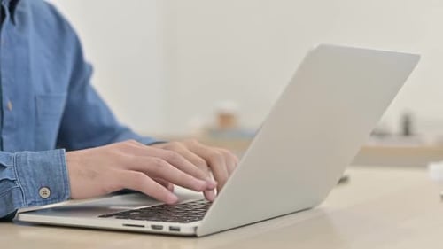 Hands Typing on a Laptop Keyboard Close Up