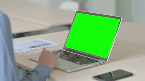 Woman Using Laptop with Green Screen