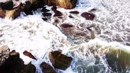 Aerial of Ocean Waves Crashing into Cliff in Bali