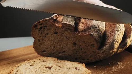 Brown Bread Sliced on a Wooden Cutting Board