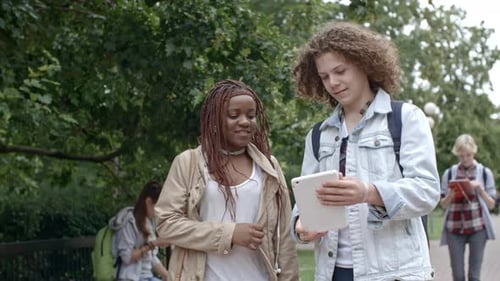 Young Boy and Girl Using Tablet on Walk