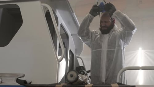 Man Taking Off Respirator and Hood