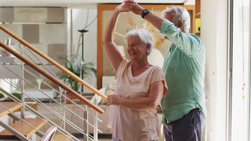 Happy Senior Couple Dancing Together at Home