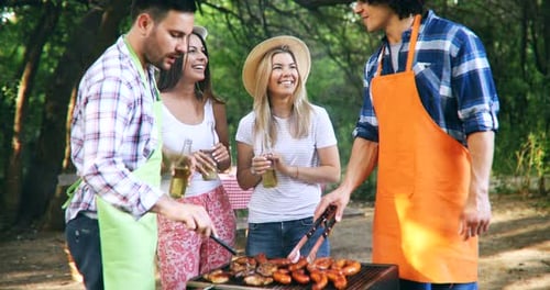 Happy Friends Having a Barbecue Party in Nature