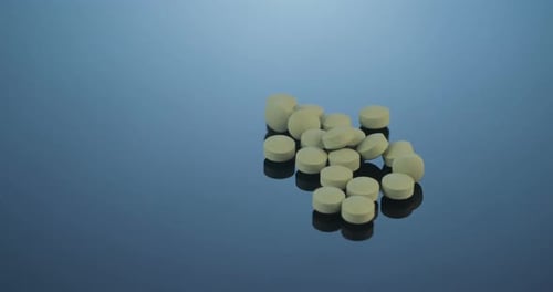 Pharmaceutical Pills on Reflective Surface Rotating