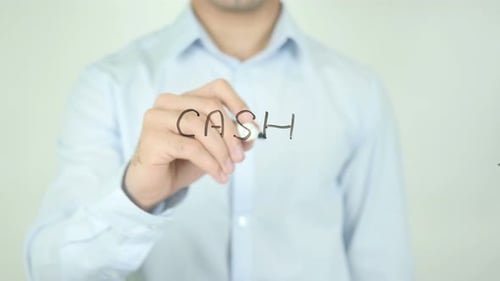Man Writes the Word CASH on Transparent Surface