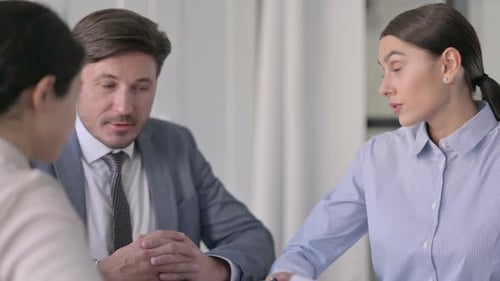 Close up of Male and Female Business People Talking in Office