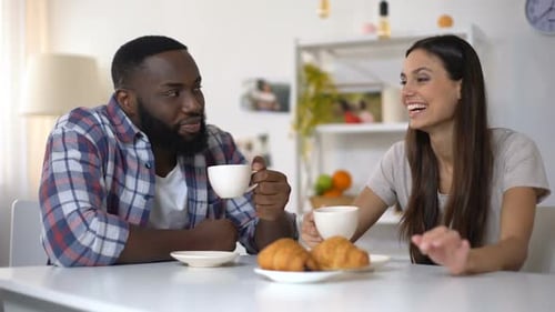 Friends Enjoying Coffee and Croissants at Home