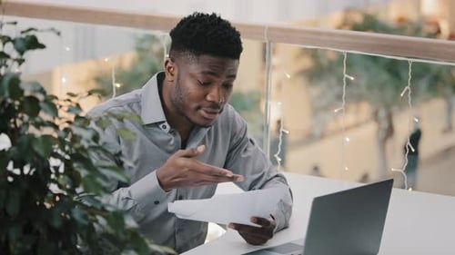 Young Man Working at Laptop in Modern Office