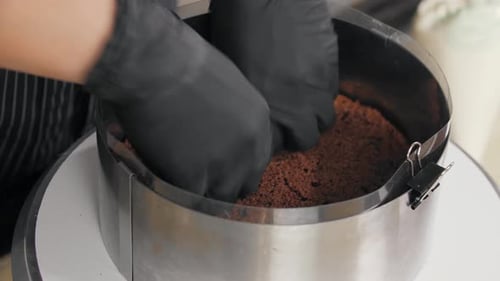 Confectioner Lowers Chocolate Sponge Cake Into a Round Shape