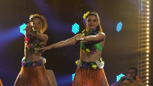 Dance Group Dancing in Short Skirts Leotards Decorated with Flowers and Wreaths of Lei