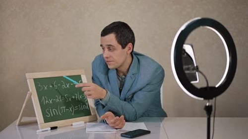 Man Teaching Mathematics Online With Chalkboard and Ring Light