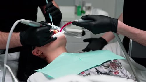 Dentist Working on Woman's Teeth in Modern Office