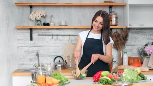Woman Preparing Fresh Salad in Bright Kitchen