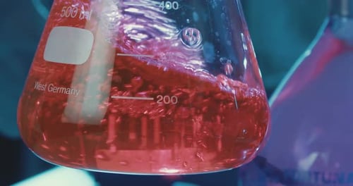 Red Liquid Swirling in Erlenmeyer Flask in Lab