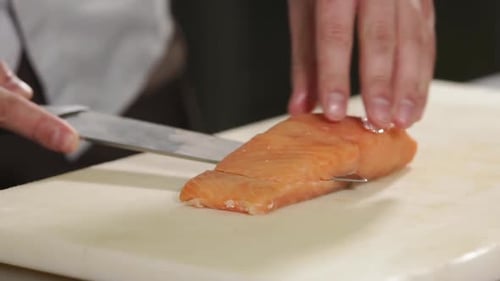 Close Up Shot of the Chef's Hands, Man Cuts a Piece of Trout in Half