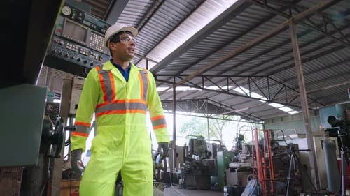 Group of Factory Workers Using Machine Equipment in Factory Workshop