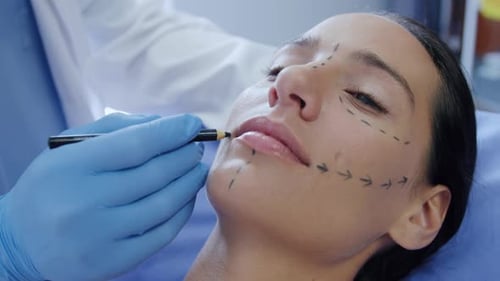 Medical Professional Marks Woman's Face