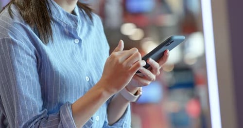 Woman use of cellphone inside shopping center