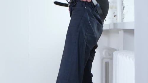 Man Putting on Dark Blue Jeans with Belt