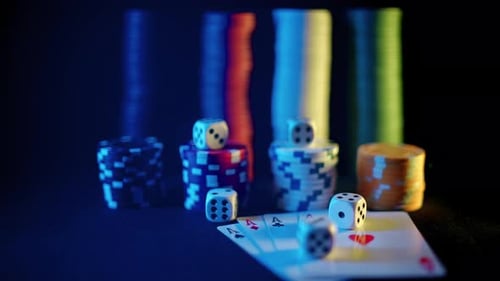 Casino Chips with Dice and Playing Cards on a Dark Table