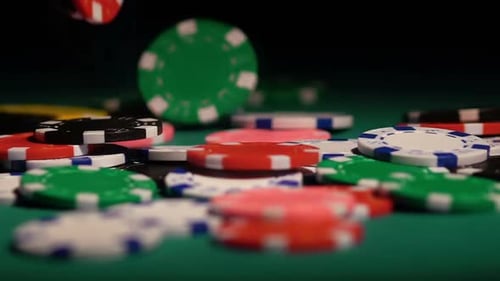 Colored Chips Falling on the Green Poker Table. Successful Player Winning Game