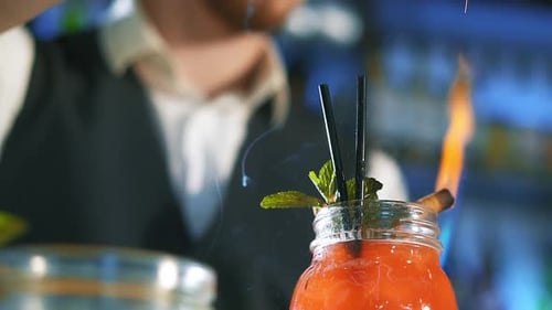 Burning Cocktail with Bartender in Background