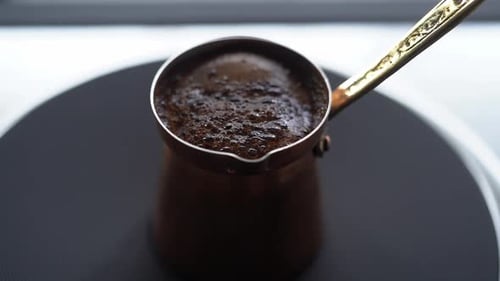 Brewing coffee in metal turk