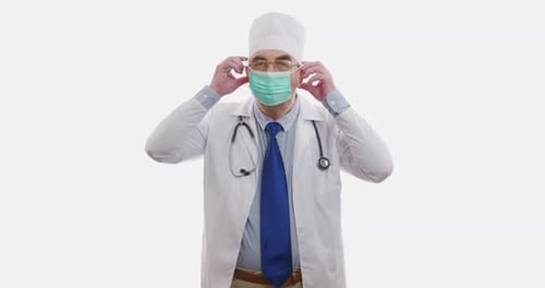 A Man Doctor Puts on a Face Shield. The Epidemic Situation. Coronavirus or COVID19. Isolated on