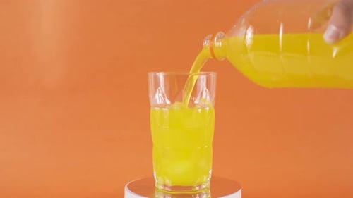 Refreshing Juice being Poured into Glass with Ice