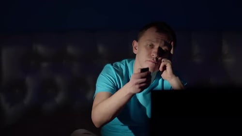 Bored Man Watching Television at Night