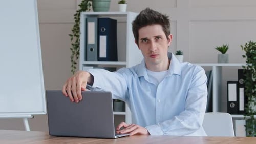 Professional Man Gesturing in Office Setting