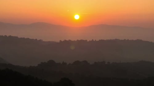 Sunrise Over Mountain Range with Layered Hills