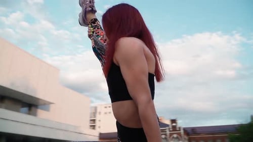 Young Woman Stretching in Urban Setting