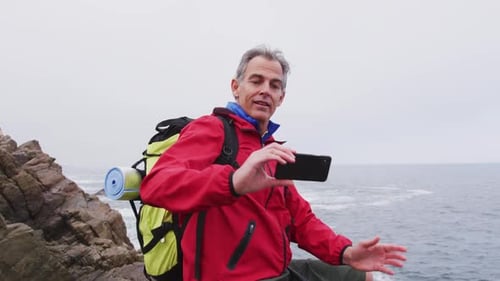 Man Taking Selfie on Rocky Ocean Coast