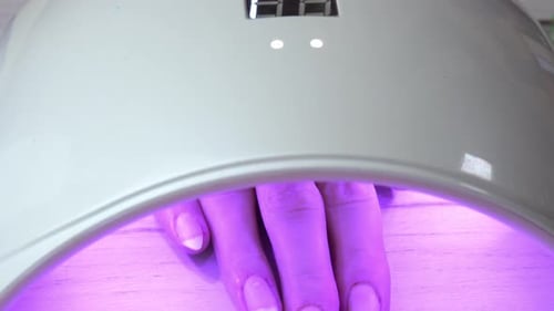 Hand in Ultraviolet Nail Lamp for Manicure