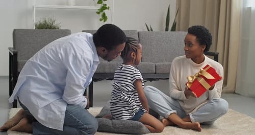 Happy Family Celebrating with Gift at Home