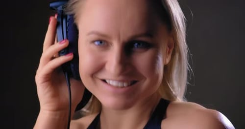 Blonde Woman Smiling with Headphones Close Up