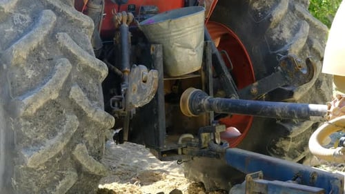 Red Tractor Parked on Farm During the Day